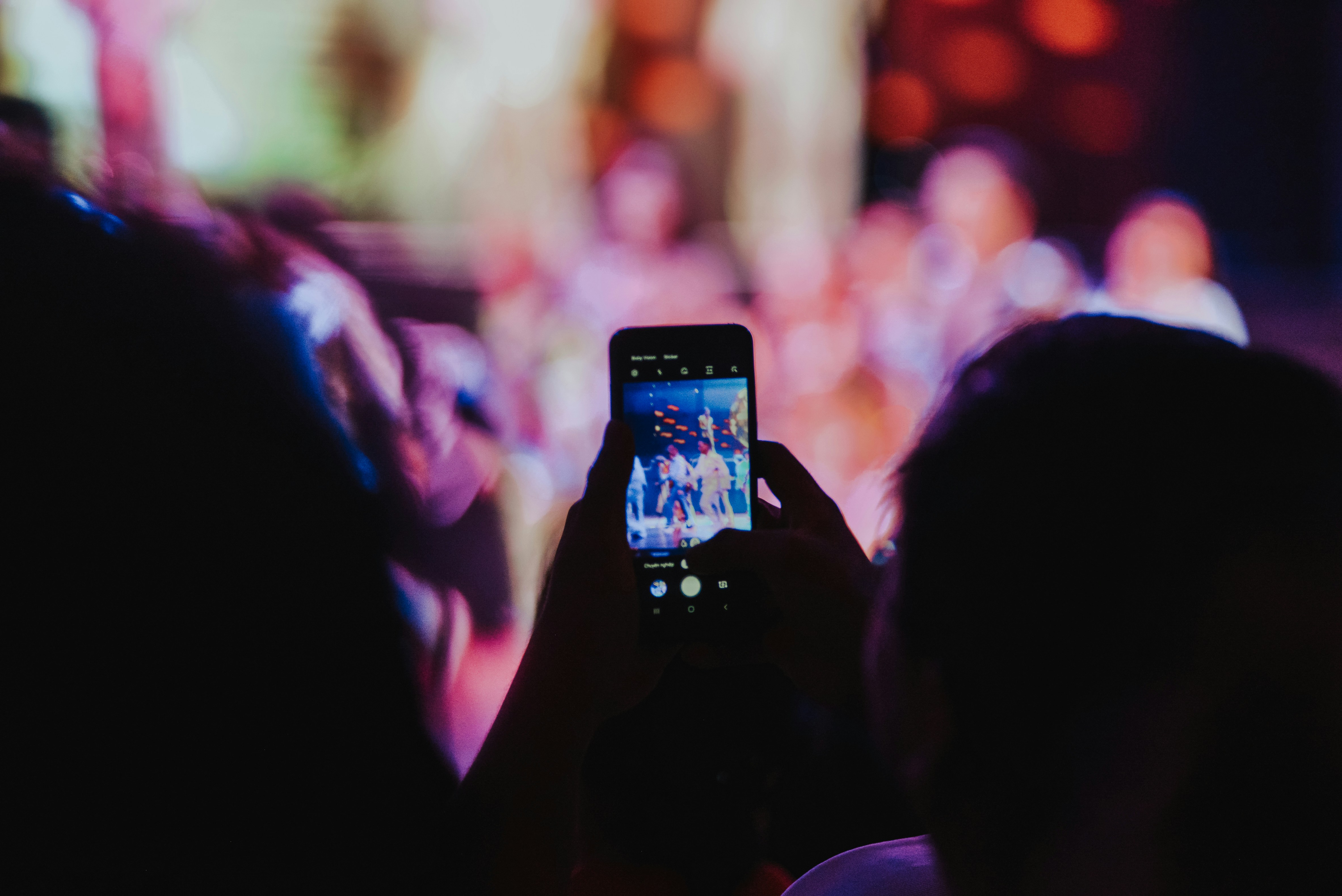Unidentified peoples are taking a photo in an exhibition event with blurred bokeh background